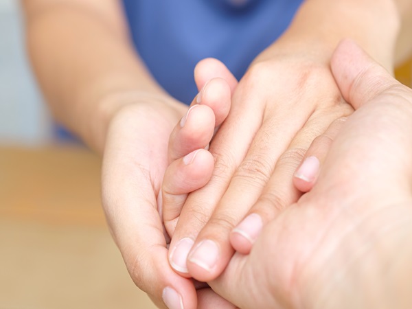 Woman and man holding hands to take care and help each other.