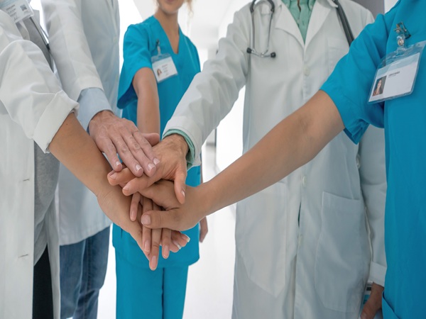 Close-up on doctors with hands together at the hospital